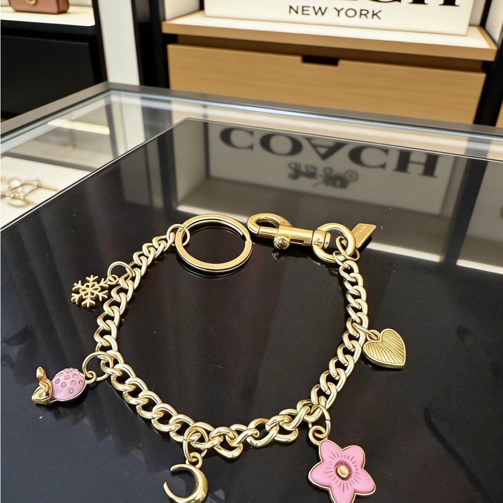 Coach Gold-Tone Charm Bracelet with Pink Enamel Flower & Mixed Charms